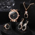 Jewelry set with black watch, earrings, and necklace on a white surface